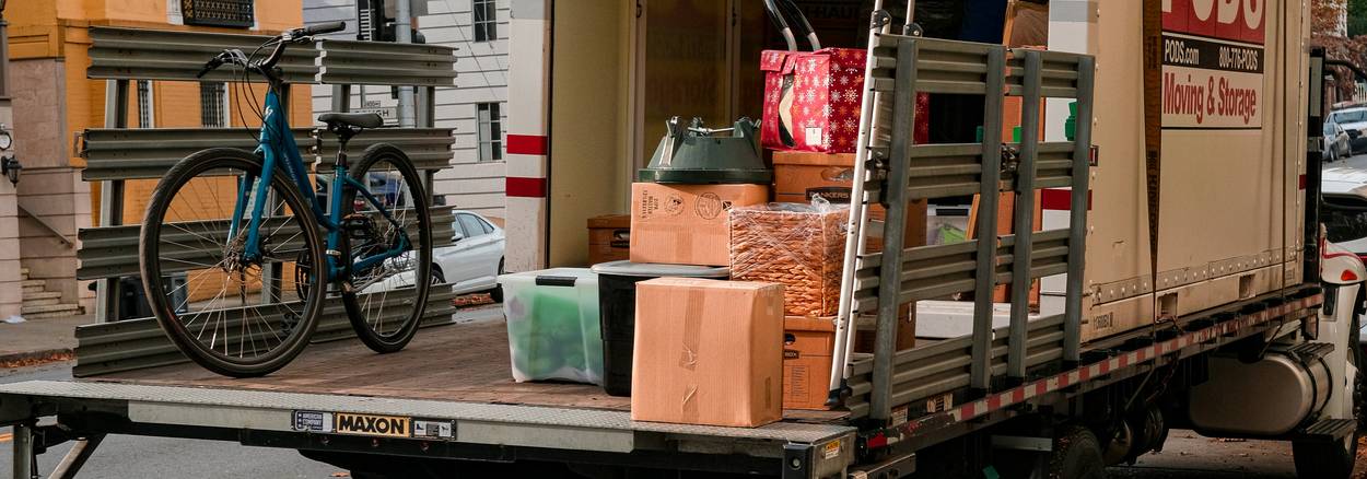 A California tenant packing moving boxes next to a lease agreement illustrating early lease termination