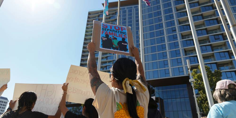 Tenants holding documents protesting a retaliatory eviction notice in California