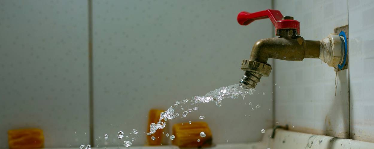 Tenant preparing a repair request letter for a leaking faucet in a California apartment