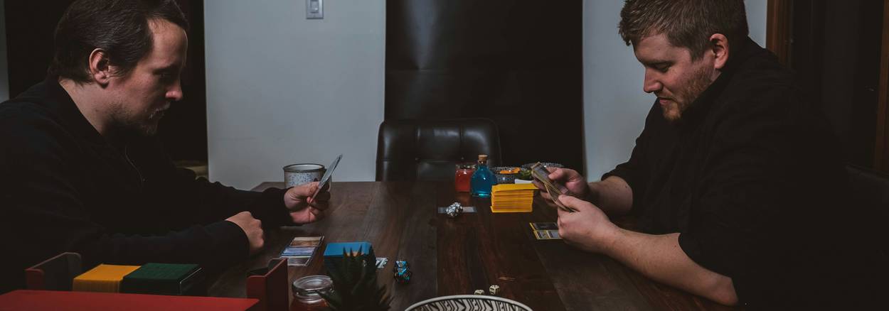 Roommates reviewing rent-split numbers at a kitchen table in their California apartment