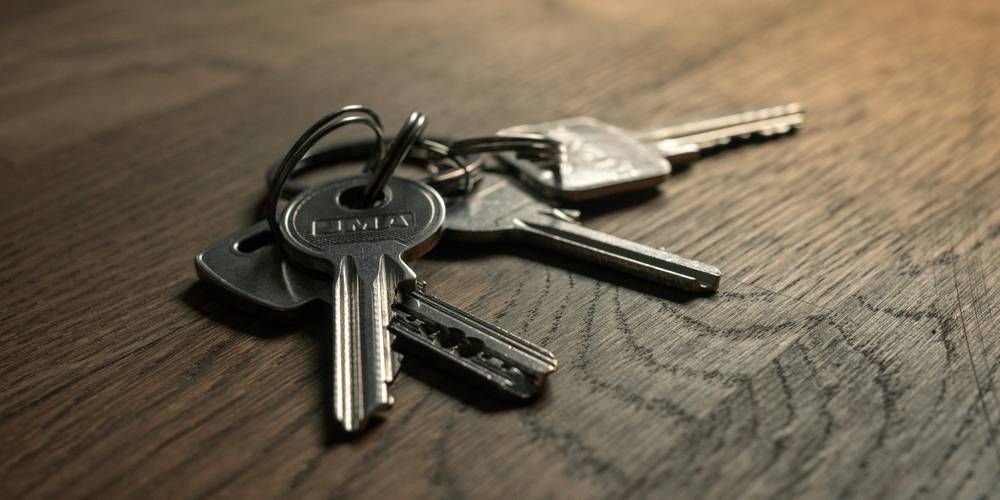 Keys resting on a California rental lease document symbolizing a tenant's security deposit
