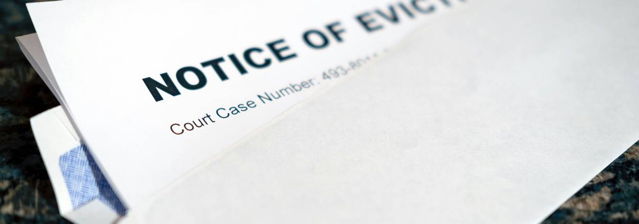 Tenant handing written 30-day notice to landlord at California apartment